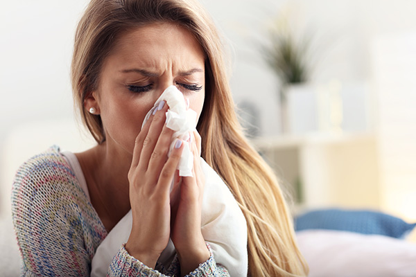 Sick woman sneezing