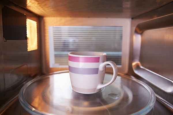 Microwave oven with a tea cup inside